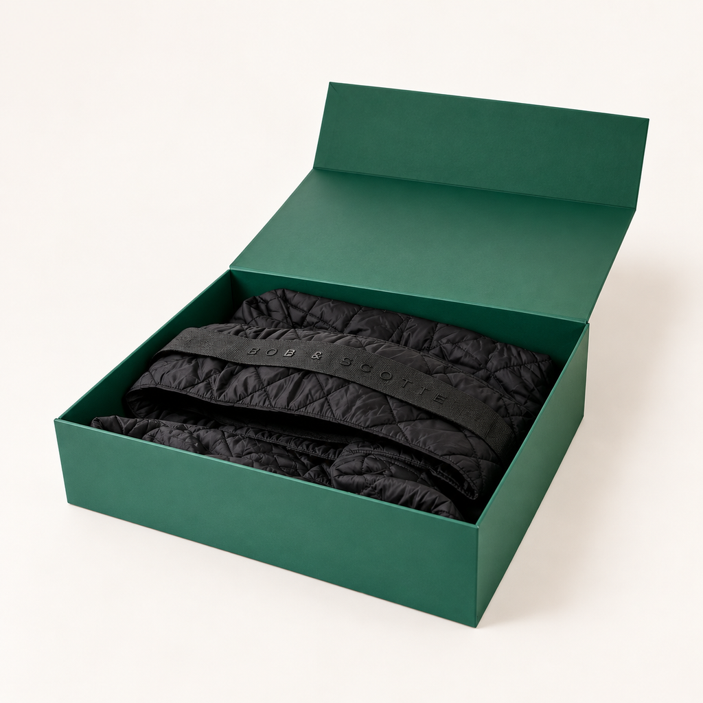Geopende groene geschenkdoos met The Bob Carrier in zwart erin